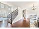 Elegant staircase with wrought iron railing and hardwood floors at 2336 Morgan Estate Dr, Buford, GA 30519