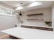 Basement bar with white quartz countertop and wooden shelves at 4373 Wieuca Ne Rd, Atlanta, GA 30342