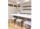 Basement wet bar with white countertop and floating shelves at 4373 Wieuca Ne Rd, Atlanta, GA 30342