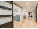 Basement hallway with sliding barn door and hardwood floors at 4373 Wieuca Ne Rd, Atlanta, GA 30342