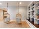 Finished basement recreation room with built-in shelving and hanging chairs at 4373 Wieuca Ne Rd, Atlanta, GA 30342