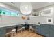 Bright basement study with L-shaped desks and large light fixture at 4373 Wieuca Ne Rd, Atlanta, GA 30342