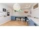 Bright basement study with L-shaped desks and large light fixture at 4373 Wieuca Ne Rd, Atlanta, GA 30342