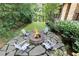 Landscaped backyard with stone fire pit and seating area at 4373 Wieuca Ne Rd, Atlanta, GA 30342