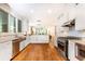 Modern kitchen with white cabinets, stainless steel appliances, and hardwood floors at 4373 Wieuca Ne Rd, Atlanta, GA 30342