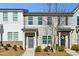 Two-story townhome with gray and white siding, landscaping, and a gray front door at 585 Mcwilliams Se Rd # 807, Atlanta, GA 30315