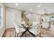 Dining area with glass table and white chairs, open to kitchen at 1330 Sw Adams Dr, Atlanta, GA 30311