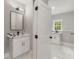 Modern bathroom with white vanity, marble countertop, and black accents at 4107 Old Suwanee Rd, Buford, GA 30518