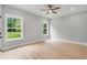 Well-lit bedroom with hardwood floors and neutral-toned walls at 4107 Old Suwanee Rd, Buford, GA 30518