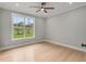 Bright bedroom with hardwood floors and a large window at 4107 Old Suwanee Rd, Buford, GA 30518