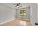 Spacious bedroom with hardwood floors, large window, and ceiling fan at 4107 Old Suwanee Rd, Buford, GA 30518