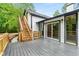 Gray composite deck with wooden stairs and sliding glass doors at 4107 Old Suwanee Rd, Buford, GA 30518