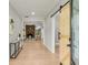 Bright entryway with light hardwood floors and a sliding barn door at 4107 Old Suwanee Rd, Buford, GA 30518