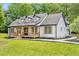 White farmhouse exterior with a wrap-around porch at 4107 Old Suwanee Rd, Buford, GA 30518