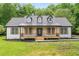 Charming farmhouse exterior with a covered porch and wooden accents at 4107 Old Suwanee Rd, Buford, GA 30518