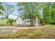 White house with a two-car garage and exterior stairs at 4107 Old Suwanee Rd, Buford, GA 30518