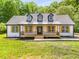 Charming farmhouse style home with a metal roof and front porch at 4107 Old Suwanee Rd, Buford, GA 30518