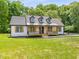 Charming farmhouse style home with a metal roof and front porch at 4107 Old Suwanee Rd, Buford, GA 30518