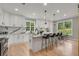 Bright kitchen with white cabinets, an island, and hardwood floors at 4107 Old Suwanee Rd, Buford, GA 30518