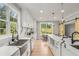 Modern kitchen with farmhouse sink, marble countertops, and stainless steel appliances at 4107 Old Suwanee Rd, Buford, GA 30518