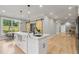 Open concept kitchen with white cabinets, large island, and sliding barn door at 4107 Old Suwanee Rd, Buford, GA 30518