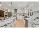 Modern kitchen with white cabinets, marble countertops, and stainless steel appliances at 4107 Old Suwanee Rd, Buford, GA 30518