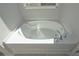 White bathtub with chrome fixtures at 477 Charleston Pl, Villa Rica, GA 30180