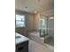 Modern bathroom boasts a soaking tub, a glass-enclosed shower, and stylish tile flooring at 1250 Winterhaven Dr, Cumming, GA 30041