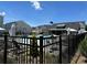 Community pool area with lounge chairs and umbrellas, surrounded by lush landscaping and wrought iron fence at 1250 Winterhaven Dr, Cumming, GA 30041