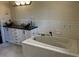 Bathroom features a soaking tub and updated vanity at 2030 Sanders Dr, Austell, GA 30168