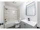 Updated bathroom with marble-look tile and gray vanity at 2106 Childress Sw Dr, Atlanta, GA 30311