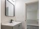 Modern bathroom with a gray vanity and updated fixtures at 2106 Childress Sw Dr, Atlanta, GA 30311