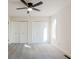 Spacious bedroom with grey carpet, ceiling fan, and double closets at 2106 Childress Sw Dr, Atlanta, GA 30311