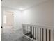 Bright hallway with grey carpet and modern staircase at 2106 Childress Sw Dr, Atlanta, GA 30311