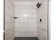 Clean shower with marble-look tile and black accents at 2106 Childress Sw Dr, Atlanta, GA 30311