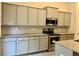 Modern kitchen with gray cabinets and granite counters at 475 Charleston Pl, Villa Rica, GA 30180