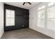 Bedroom featuring dark accent wall, wood shelves, wood floors, and white trim at 770 Grove Bnd, Decatur, GA 30030