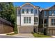 Three-story home with light-grey siding, two-car garage, and a balcony at 770 Grove Bnd, Decatur, GA 30030