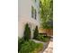 Charming front entrance with lush greenery, a neatly landscaped garden, and classic white siding at 770 Grove Bnd, Decatur, GA 30030