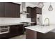 Modern kitchen with granite countertops, stainless steel appliances, and dark wood cabinetry at 770 Grove Bnd, Decatur, GA 30030