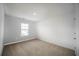 Spacious bedroom with gray accent wall and neutral carpet, featuring a large window at 816 Graeme Dr, Mcdonough, GA 30252