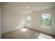 Bright bedroom with neutral walls and carpet, featuring two large windows at 816 Graeme Dr, Mcdonough, GA 30252