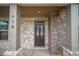 Elegant front door entry with stone accents at 816 Graeme Dr, Mcdonough, GA 30252