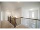 Upstairs hallway with wood railing and carpet at 816 Graeme Dr, Mcdonough, GA 30252