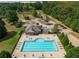 Community pool with surrounding lounge chairs and a clubhouse at 816 Graeme Dr, Mcdonough, GA 30252