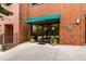 Brick building with a green awning and glass double doors at 115 W Peachtree Nw # 704, Atlanta, GA 30313