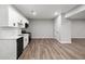 Modern basement kitchen features white cabinets, stainless steel appliances, and vinyl flooring at 1590 Highland Farm Dr, Suwanee, GA 30024