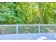 Deck view showcasing lush green trees and tranquil natural landscape at 1590 Highland Farm Dr, Suwanee, GA 30024