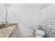 Cozy bathroom featuring granite countertops, white fixtures, and a decorative shower curtain at 2201 Cumberland Se Ct, Smyrna, GA 30080