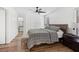 Comfortable bedroom featuring a ceiling fan, wood floors, and a serene color scheme at 2201 Cumberland Se Ct, Smyrna, GA 30080